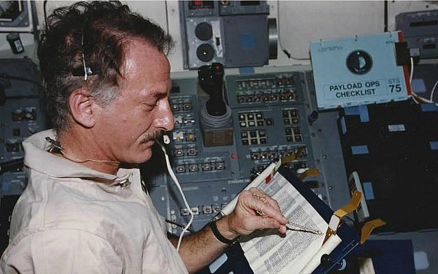 Jeffrey Hoffman reads from the Torah aboard the space shuttle Columbia during a 1996 mission. (Courtesy of Hoffman)