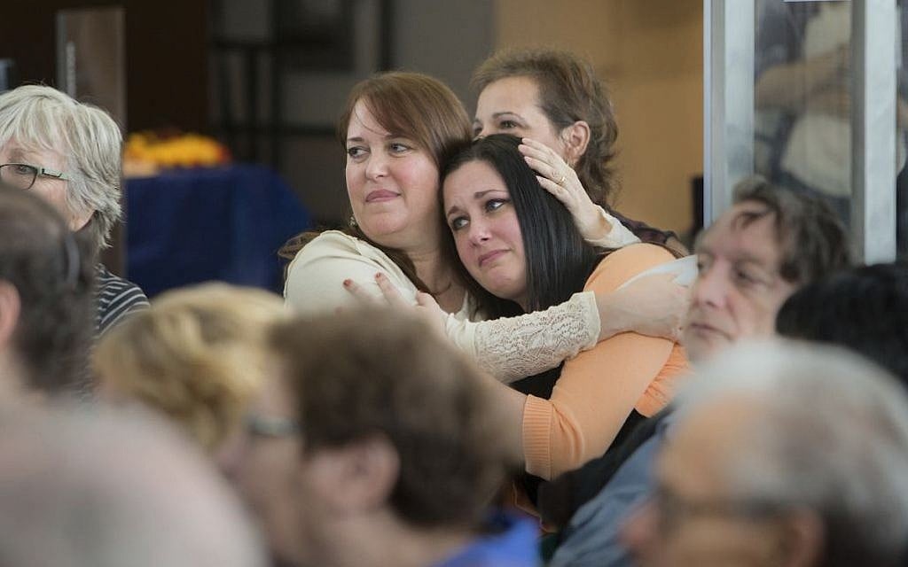 In this Oct. 30, 2016 photo Lorrie Zullo, left, and Jillian Eisman embrace at the Kupferberg Holocaust Center at Queensborough Community College in the Queens borough of New York. (Leo Correa/Queensborough Community College via AP) In this Oct. 30, 2016 photo Lorrie Zullo, left, and Jillian Eisman embrace at the Kupferberg Holocaust Center at Queensborough Community College in the Queens borough of New York. (Leo Correa/Queensborough Community College via AP)