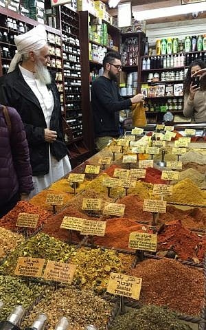 Jakob Mowakkot and his herbs and spices (Jessica Steinberg/Times of Israel)