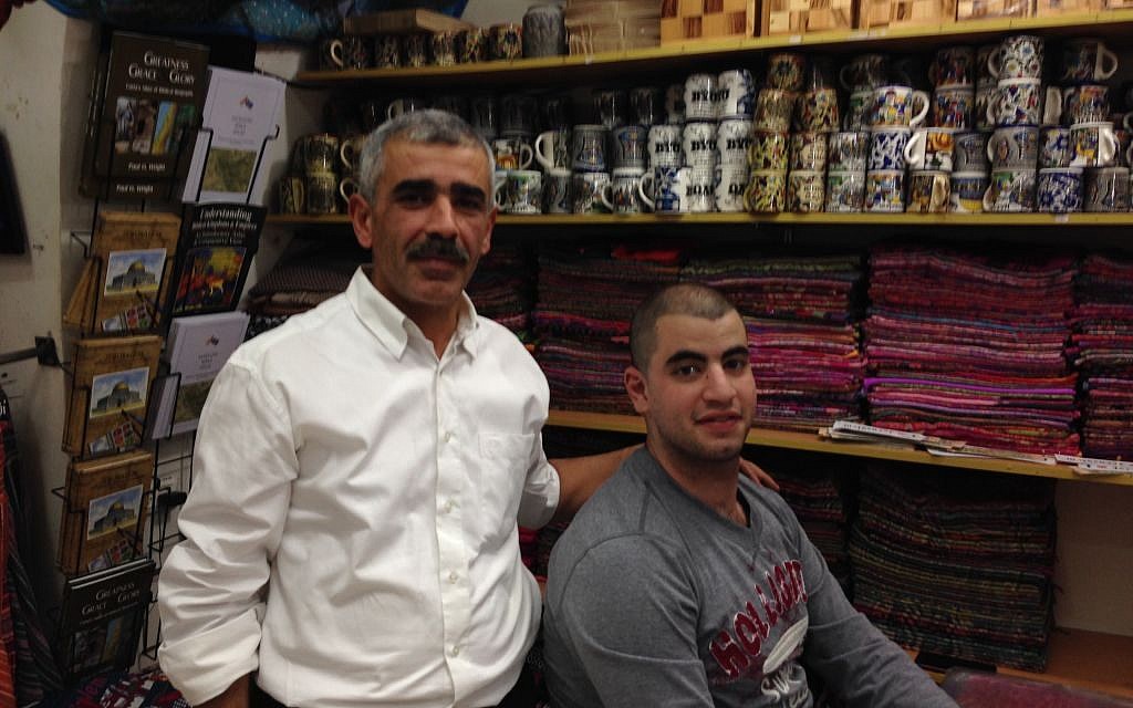 Nidal and his son (unnamed) in his shop on Christian Quarter Road in the Old City of Jerusalem on November 9, 2016 (Tamar Pileggi/Times of Israel) Nidal and his son (unnamed) in his shop on Christian Quarter Road in the Old City of Jerusalem on November 9, 2016 (Tamar Pileggi/Times of Israel)