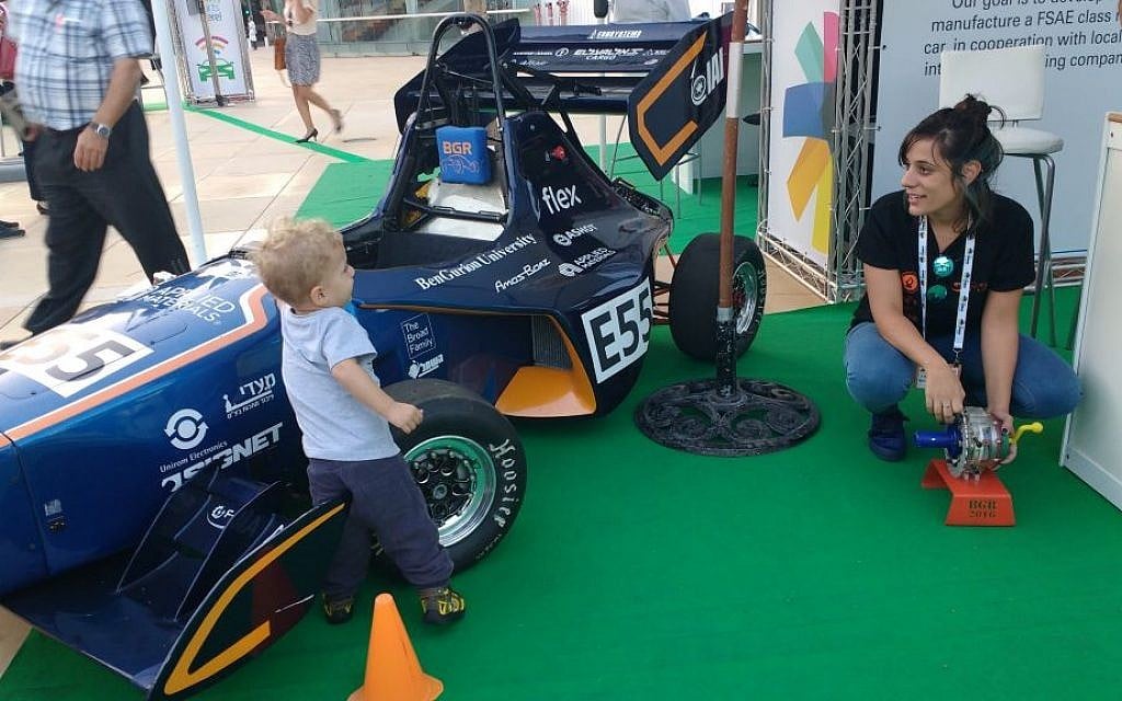 Lital Ben Shitrit, a Ben Gurion University student who worked on the BGR Ben Gurion Racing Team, demonstrates the use of carbon fiber to a young car enthusiast at the Israel Fuel Choices Initiative summit in Tel Aviv on November 3, 2016. (Melanie Lidman/Times of Israel) Lital Ben Shitrit, a Ben Gurion University student who worked on the BGR Ben Gurion Racing Team, demonstrates the use of carbon fiber to a young car enthusiast at the Israel Fuel Choices Initiative summit in Tel Aviv on November 3, 2016. (Melanie Lidman/Times of Israel)