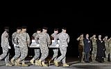 In this Monday, November 7, 2016 file photo, an Army carry team moves a transfer case containing the remains of Sgt. 1st Class Matthew C. Lewellen past Army Secretary Eric Fanning, fifth from right, Undersecretary of Defense for Intelligence Marcel Lettre, third from right, and Gen. Daniel B. Allyn, right, Army vice chief of staff, at Dover Air Force Base, Delaware.