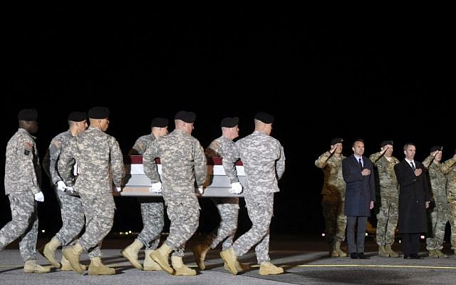 In this Monday, November 7, 2016 file photo, an Army carry team moves a transfer case containing the remains of Sgt. 1st Class Matthew C. Lewellen past Army Secretary Eric Fanning, fifth from right, Undersecretary of Defense for Intelligence Marcel Lettre, third from right, and Gen. Daniel B. Allyn, right, Army vice chief of staff, at Dover Air Force Base, Delaware. In this Monday, November 7, 2016 file photo, an Army carry team moves a transfer case containing the remains of Sgt. 1st Class Matthew C. Lewellen past Army Secretary Eric Fanning, fifth from right, Undersecretary of Defense for Intelligence Marcel Lettre, third from right, and Gen. Daniel B. Allyn, right, Army vice chief of staff, at Dover Air Force Base, Delaware.
