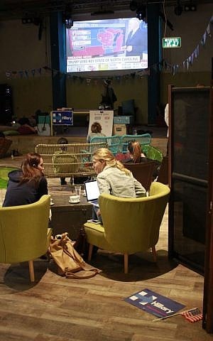 Two supporters of Democrat candidate Hillary Clinton watch the results of the 2016 US election in Tel Aviv's Abraham Hostel on November 9, 2016. (Judah Ari Gross/Times of Israel)