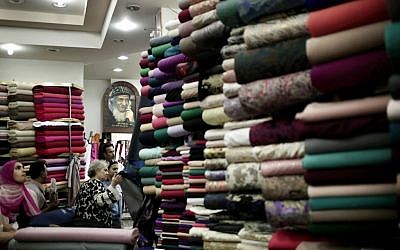 Egyptian women look at fabric inside a store in Wekalet El Balah, Cairo's famous fabric market, in Egypt, October 22, 2016. (AP Photo/Nariman El-Mofty)