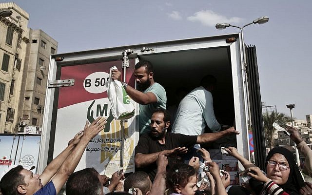 In this Wednesday, Oct. 26, 2016 file photo, volunteers from the Kheir Zaman local supermarket sell a kilogram of sugar for 7.50 L.E. (0.84 US cents), in the Sayeda Zeinab neighborhood of Cairo, Egypt. (AP Photo/Nariman El-Mofty, File) In this Wednesday, Oct. 26, 2016 file photo, volunteers from the Kheir Zaman local supermarket sell a kilogram of sugar for 7.50 L.E. (0.84 US cents), in the Sayeda Zeinab neighborhood of Cairo, Egypt. (AP Photo/Nariman El-Mofty, File)