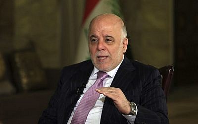 Iraq's Prime Minister Haider al-Abadi, center, speaks during an interview with the Associated Press in Baghdad, Iraq, Monday, Nov. 28, 2016. (AP Photo/Khalid Mohammed)