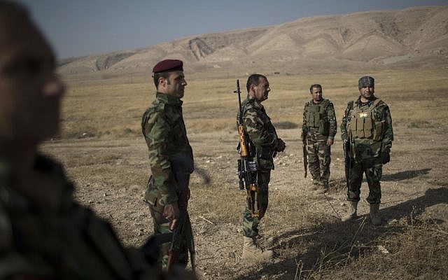 Kurdish Peshmerga fighters gather near a frontline during fighting with Islamic State militants in Bashiqa, east of Mosul, Iraq. Tuesday, Nov. 8, 2016. (AP Photo/Felipe Dana, File).