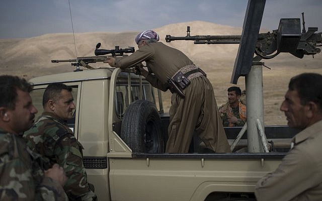Taken on Tuesday, Nov. 8, 2016, a Kurdish Peshmerga fighter looks at Islamic State militant positions during heavy fighting in Bashiqa, east of Mosul, Iraq. (AP Photo/Felipe Dana, File) Taken on Tuesday, Nov. 8, 2016, a Kurdish Peshmerga fighter looks at Islamic State militant positions during heavy fighting in Bashiqa, east of Mosul, Iraq. (AP Photo/Felipe Dana, File)