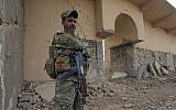 An Iraqi soldier stands guard at the entrance of the ancient site of Nimrud, which was destroyed by Islamic State militants, November 16, 2016. (AP/Hussein Malla)