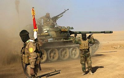 Fighters of the Popular Mobilization Forces stand at the front line against Islamic State militants outside Mosul, Iraq, Saturday, Nov. 26, 2016. (AP Photo/Anmar Khalil)