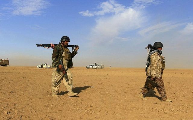 Fighters of the Popular Mobilization Forces stand at the front line against Islamic State militants outside Mosul, Iraq, Saturday, Nov. 26, 2016. (AP Photo/Anmar Khalil)