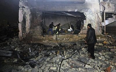 Civilians search for survivors in the rubble at the scene of a car bomb attack near the city of Hilla about 95 kilometers (60 miles) south of Baghdad, Iraq, Thursday, Nov. 24, 2016. (AP/Hadi Mizban)