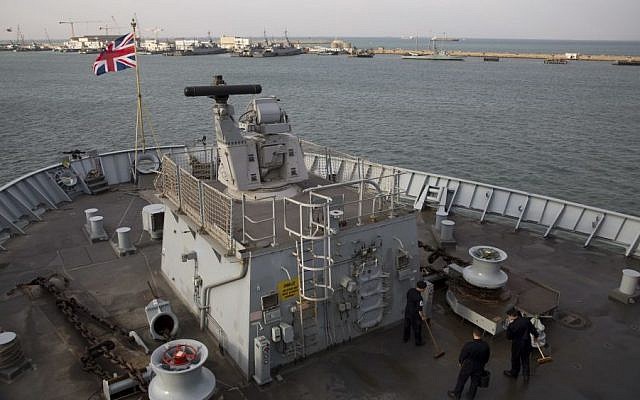 The crew of the British Royal Navy amphibious assault ship HMS Bulwark work as the ship is anchored in Haifa port, Israel, Tuesday, Nov. 22, 2016. (AP/Ariel Schalit)
