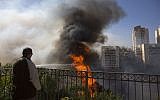 A man watches wildfires in Haifa, Israel, Thursday, Nov. 24, 2016. (AP Photo/Ariel Schalit)