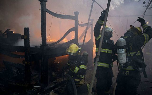 Israeli firefighters work to extinguish a flame in a home in Haifa, Thursday, Nov. 24, 2016. (AP Photo/Ariel Schalit)