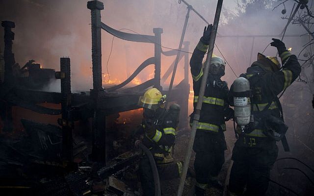 Firefighters work in a home in Haifa, Israel, Thursday, November 24, 2016. (AP Photo/Ariel Schalit)