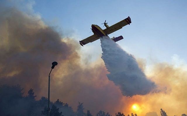 A firefighting plane from Greece fights a wildfire over Haifa, Israel, Thursday, Nov. 24, 2016. (AP Photo/Ariel Schalit) A firefighting plane from Greece fights a wildfire over Haifa, Israel, Thursday, Nov. 24, 2016. (AP Photo/Ariel Schalit)