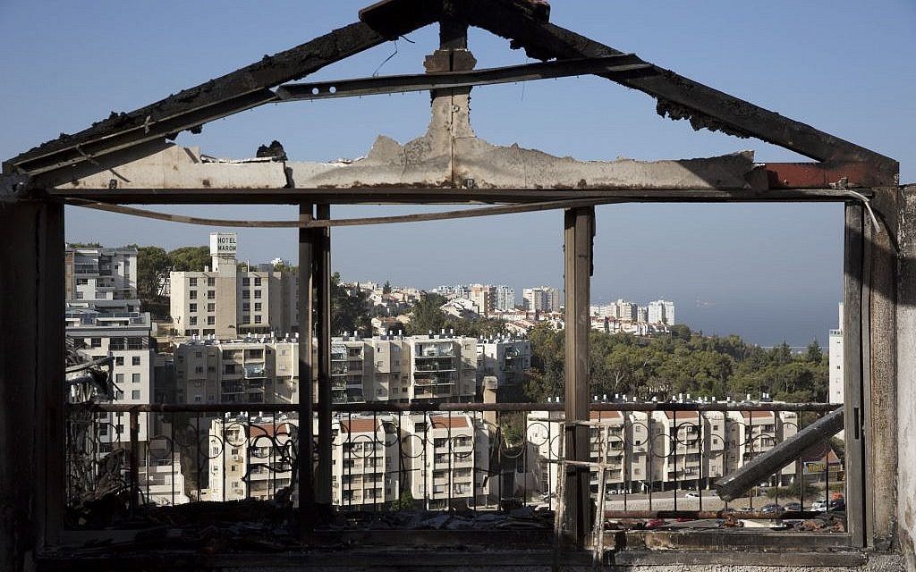 The Mediterranean sea and parts of the city can bee sen through a burned house following wildfires in Haifa, Israel, Friday, Nov. 25, 2016. (AP Photo/Ariel Schalit) The Mediterranean sea and parts of the city can bee sen through a burned house following wildfires in Haifa, Israel, Friday, Nov. 25, 2016. (AP Photo/Ariel Schalit)
