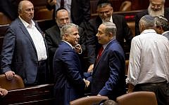 Prime Minister Benjamin Netanyahu (right) shakes hands with Yair Lapid, leader of the Yesh Atid party, in the Knesset plenum, October 31, 2016. (AP Photo/Sebastian Scheiner)