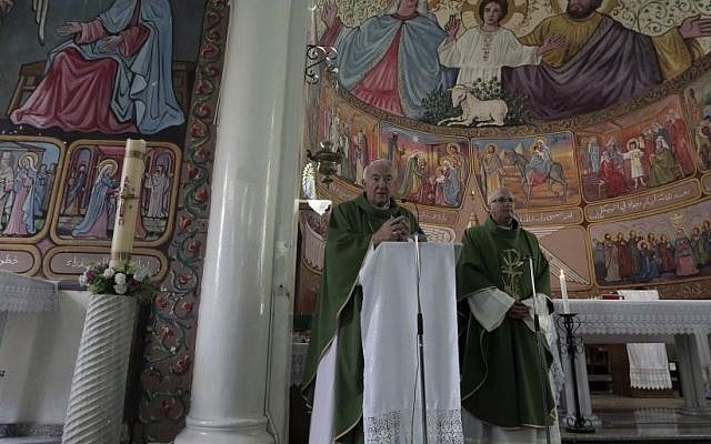 Cardinal Vincent Nichols, Archbishop of Westminster, left, stands next to Father Imad Twal, the general secretary of the Latin Patriarchate of Jerusalem, as he holds a Sunday mass at the Holy Family Catholic Church in Gaza City, November 6, 2016. (AP Photo/ Khalil Hamra) Cardinal Vincent Nichols, Archbishop of Westminster, left, stands next to Father Imad Twal, the general secretary of the Latin Patriarchate of Jerusalem, as he holds a Sunday mass at the Holy Family Catholic Church in Gaza City, November 6, 2016. (AP Photo/ Khalil Hamra)