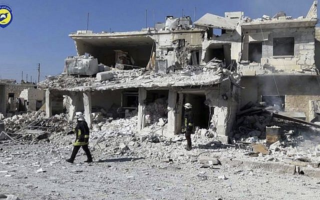 This photo provided by the Syrian Civil Defense White Helmets shows Civil Defense workers walk past damaged buildings after airstrikes hit in Abian Saman town, in rural western Aleppo province, Syria, Saturday, Nov. 5, 2016. (Syrian Civil Defense White Helmets via AP) This photo provided by the Syrian Civil Defense White Helmets shows Civil Defense workers walk past damaged buildings after airstrikes hit in Abian Saman town, in rural western Aleppo province, Syria, Saturday, Nov. 5, 2016. (Syrian Civil Defense White Helmets via AP)
