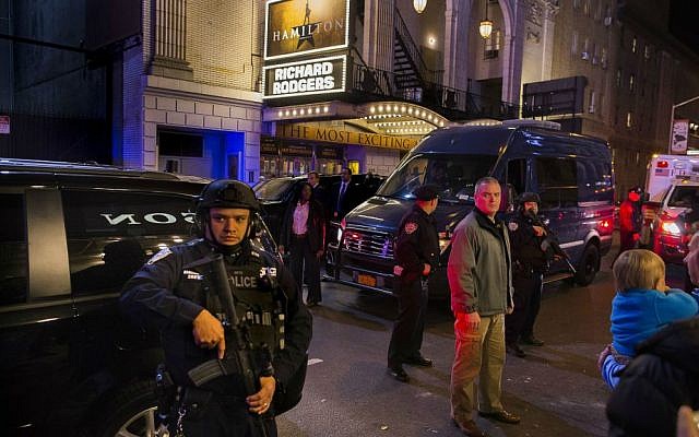 Heavily armed police stand guard as a motorcade carrying Vice President-elect Mike Pence, center, leaves the Richard Rodgers Theatre after a performance of "Hamilton," in New York, Friday, Nov. 18, 2016. (AP Photo/Andres Kudacki)