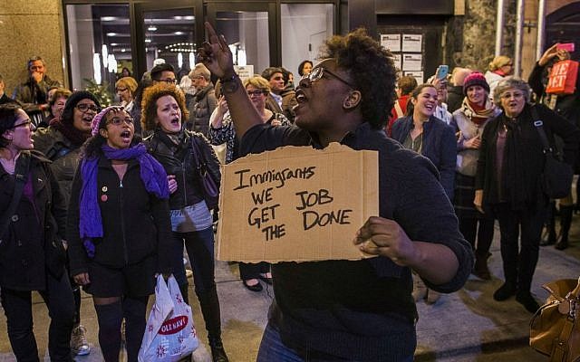 Protesters shout slogans at Vice President-elect Mike Pence as he leaves the Richard Rodgers Theatre after a performance of "Hamilton," in New York, Friday, Nov. 18, 2016. (AP Photo/Andres Kudacki)
