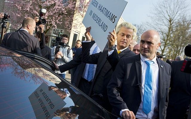 Geert Wilders, leader of the anti-Islam Freedom Party, holds a sign reading "No Hate Imams in the Netherlands" in Utrecht, central Netherlands, April 9, 2015. (AP Photo/Peter Dejong, File)
