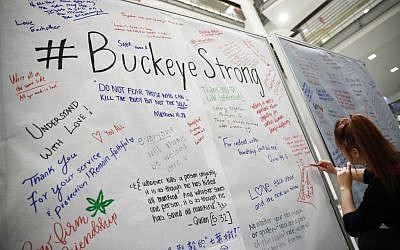 Student Ashley Greivenkamp signs a community message board at The Ohio State University student union Tuesday, Nov. 29, 2016, following an attack at on campus the previous day, in Columbus, Ohio. (AP Photo/John Minchillo)