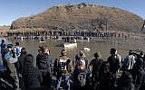 Dakota Access Pipeline protesters stand in the foreground and in the waist-deep water of the Cantapeta Creek, northeast of the Oceti Sakowin Camp, near Cannon Ball, North Dakota, Wednesday, November 2, 2016. (Mike Mccleary/The Bismarck Tribune via AP)