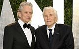 In this February 26, 2012 file photo, Michael Douglas, left, and Kirk Douglas arrive at the Vanity Fair Oscar party in West Hollywood, California. (AP Photo/Evan Agostini, File)