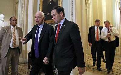 Sen. John McCain, R-Arizona, left, and Sen. Marco Rubio, R-Florida, followed by Sen. Mark Warner, D-Virginia, and Sen. Richard Burr, R-North Carolina, walk to their caucus organizing meeting to elect their leadership for the 115th Congress, Wednesday, Nov. 16, 2016, on Capitol Hill in Washington. (AP Photo/Alex Brandon)