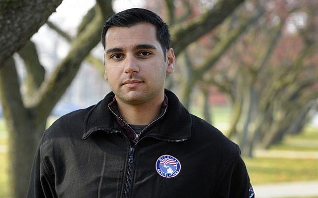 In a photo from Thursday, Nov. 17, 2016, Oakland University senior Michael Banerian stands on campus in Rochester, Mich. Banerian, a Republican representative to the Electoral College has been receiving death threats. (AP Photo/Jose Juarez)
