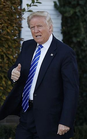 President-elect Donald Trump give the thumbs-up as he arrives at the Trump National Golf Club Bedminster clubhouse in Bedminster, N.J., Saturday, Nov. 19, 2016. (AP Photo/Carolyn Kaster)