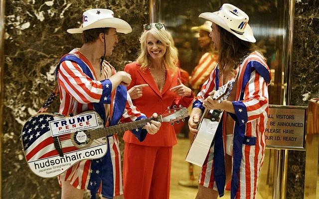 Kellyanne Conway, campaign manager for President-elect Donald Trump, center, listens to a song by 'The Naked Cowboy,' in the lobby of Trump Tower, in New York, November 28, 2016. (AP/Evan Vucci) 
