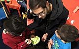 Yacob Yanai, an Israeli living in Berlin, volunteers with refugee children at the Spandau refugee shelter. November 13, 2016. (Courtesy)