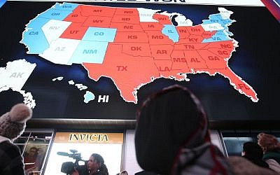 People watch the election results in Times Square in New York City, USA, November 9, 2016. (Noam Revkin FentonFlash90)