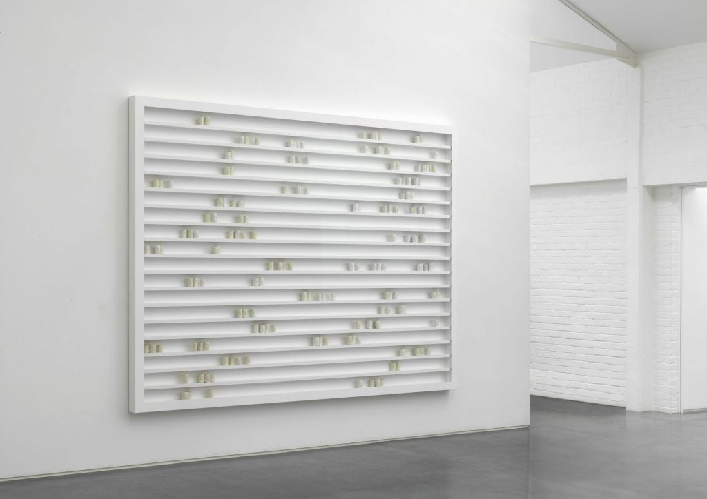 Front view of 'a place made fast' by Edmund de Waal, 2014. 160 porcelain vessels with gilding in a wood, aluminum and glass cabinet. (Mike Bruce, Courtesy Gagosian Gallery) Front view of 'a place made fast' by Edmund de Waal, 2014. 160 porcelain vessels with gilding in a wood, aluminum and glass cabinet. (Mike Bruce, Courtesy Gagosian Gallery)