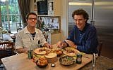 Danny Ashkenazi, left, and Tom Franz preparing to eat filet Osvaldo Aranha in Jerusalem, November 2016. (Courtesy of World Bnei Akiva/via JTA)