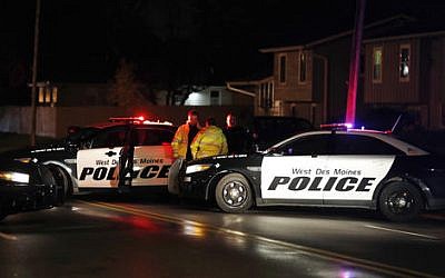 Law enforcement officials investigate at the scene of a shooting, Wednesday, Nov. 2, 2016, in Urbandale, Iowa. Two Des Moines area police officers were shot to death early Wednesday in ambush-style attacks while they were sitting in their patrol cars. (AP Photo/Charlie Neibergall)