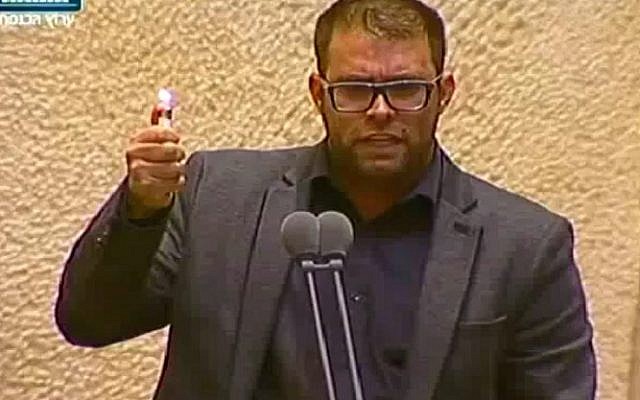 Likud MK Oren Hazan holds up a lighter in the Knesset plenum on November 30, 2016, calling it the 'new weapon of terrorists' amid claims that arson caused at least some of the recent wave of wildfires to hit the country (screen capture: Channel 10) 