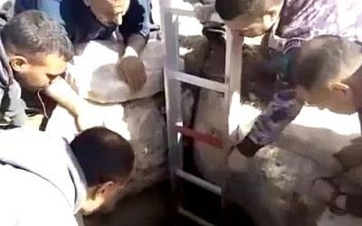 Palestinian Civil Defense members rescue an Israeli settler who had been stuck in a pit for six days, November 26, 2016. (Screenshot/Channel 10)