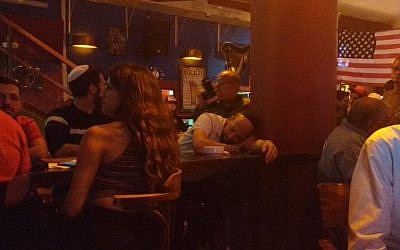 A tired Trump supporter struggles to stay awake at a watch party in downtown Jerusalem in the early morning hours of November 9, 2016. (Melanie Lidman/Times of Israel)