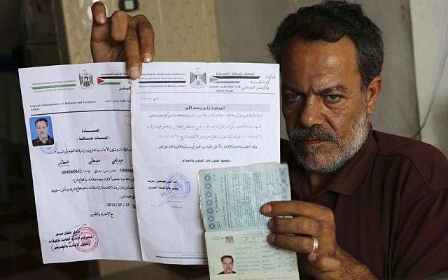 Syrian refugee, Majed al-Attar, poses while showing his expired Syrian passport and Palestinian identification documents at his family's rented house in Rafah, Gaza, October 31, 2016 (AP Photo/Adel Hana) Syrian refugee, Majed al-Attar, poses while showing his expired Syrian passport and Palestinian identification documents at his family's rented house in Rafah, Gaza, October 31, 2016 (AP Photo/Adel Hana)