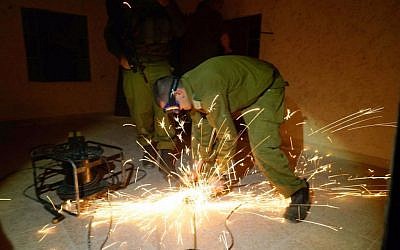IDF troops prepare to fill the bedroom of an accomplice in the Sarona Market terror attack with cement in his home village of Yatta, outside Hebron, on November 10, 2016. (IDF Spokesperson's Unit)