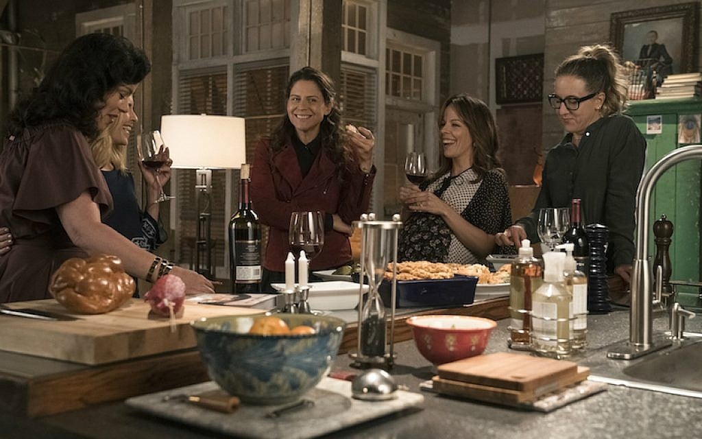 On 'Younger,' Maggie (Debi Mazar), left, hosts a Shabbat dinner for her love interest, Malkie (Sally Pressman), and her friends. (Courtesy of TV Land/via JTA) On 'Younger,' Maggie (Debi Mazar), left, hosts a Shabbat dinner for her love interest, Malkie (Sally Pressman), and her friends. (Courtesy of TV Land/via JTA)