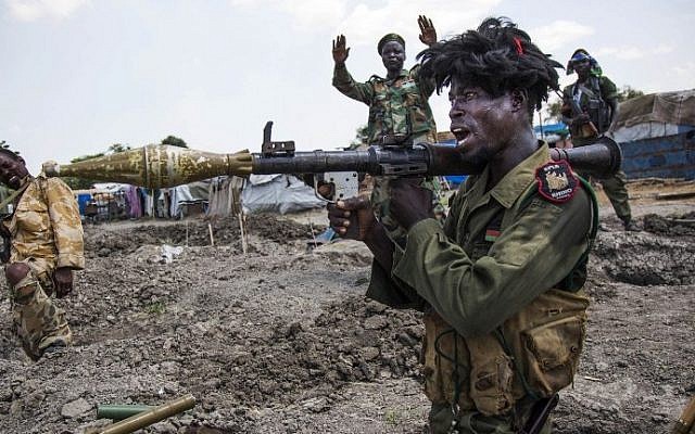 Soldiers of the Sudan People Liberation Army (SPLA) celebrate while standing in trenches in Lelo, outside Malakal, northern South Sudan, on October 16, 2016.
(AFP Photo/Albert Gonzalez Farran) Soldiers of the Sudan People Liberation Army (SPLA) celebrate while standing in trenches in Lelo, outside Malakal, northern South Sudan, on October 16, 2016.
(AFP Photo/Albert Gonzalez Farran)