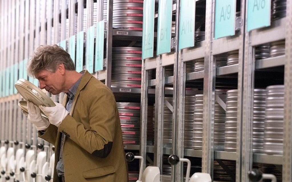 Nikolaus Wostry, head of Film Collections of Filmmarchiv Austria, smells an old film in a special storage at Filmarchive Austria in Laxenburg on November 15, 2016. (AFP PHOTO / JOE KLAMAR)