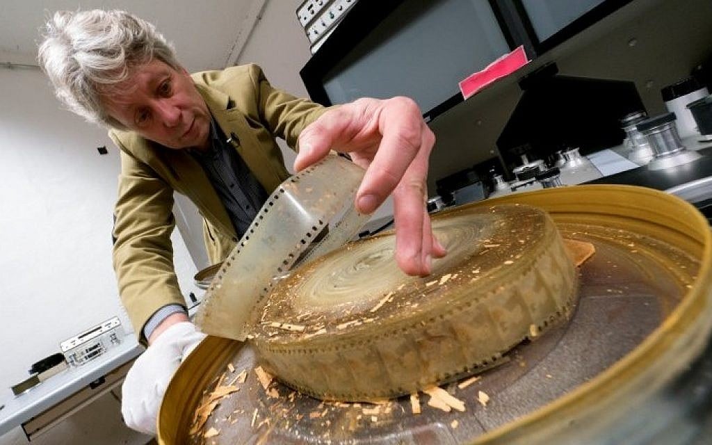 Nikolaus Wostry, head of Film Collections of Filmmarchiv Austria, shows an old damaged film at Filmarchiv Austria in Laxenburg on November 15, 2016. (AFP PHOTO / JOE KLAMAR)